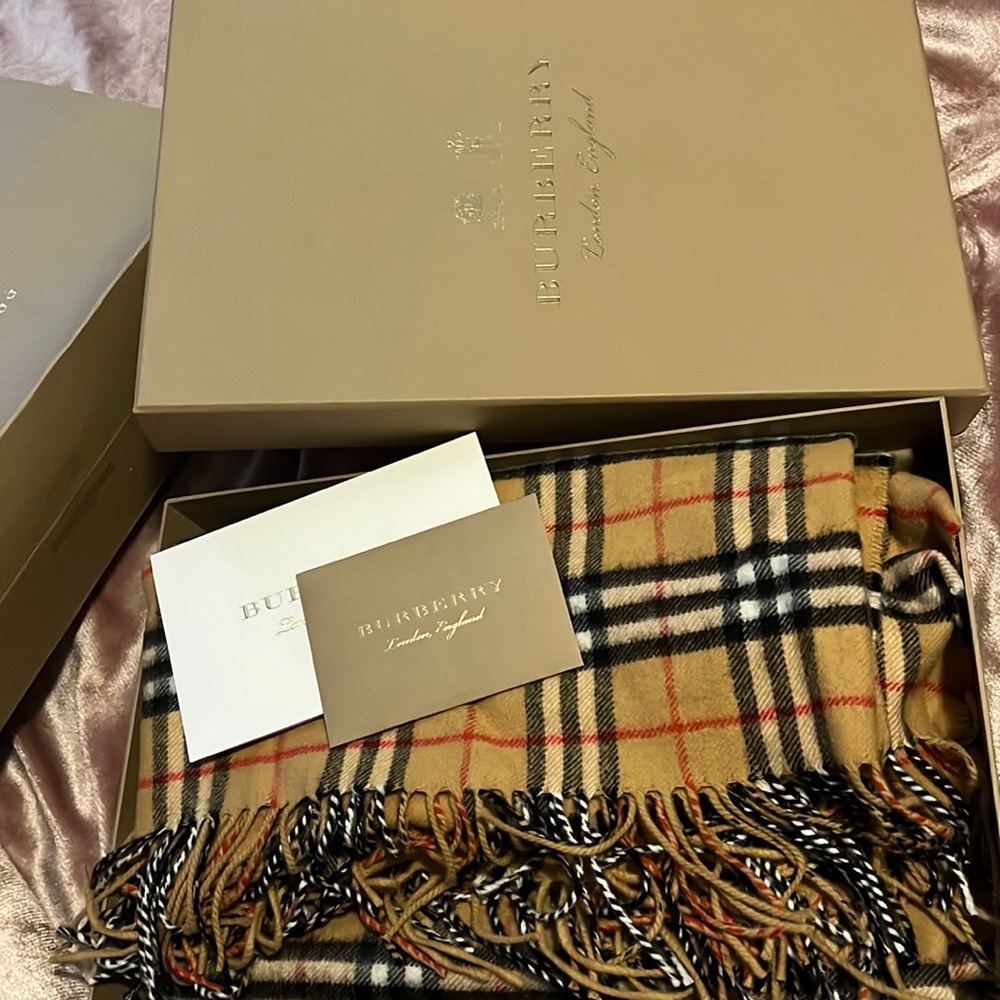 It is a Burberry cape never used still in the box & bag.